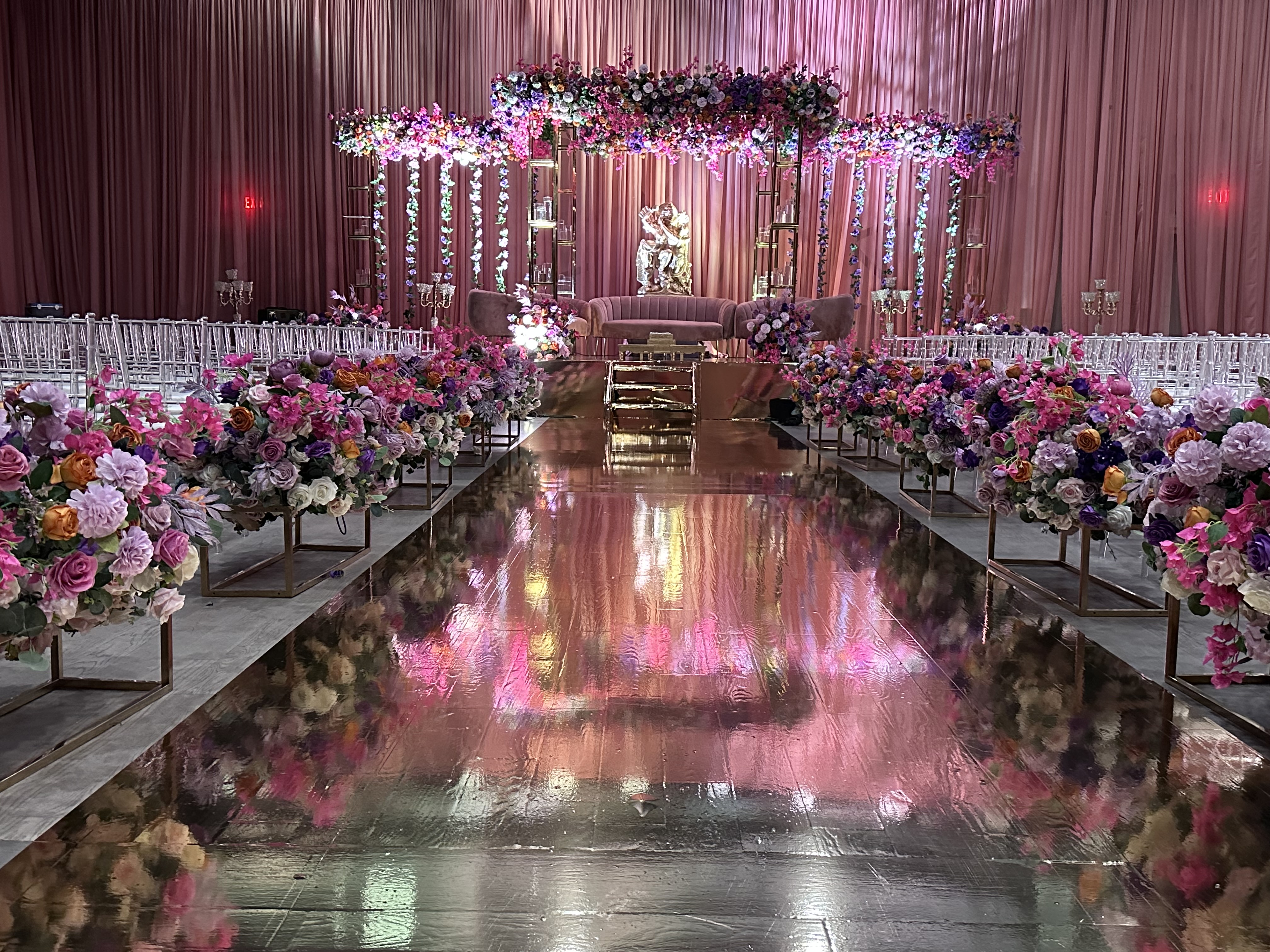 Floral wedding ceremony and reception setup at Palacio Event Centre